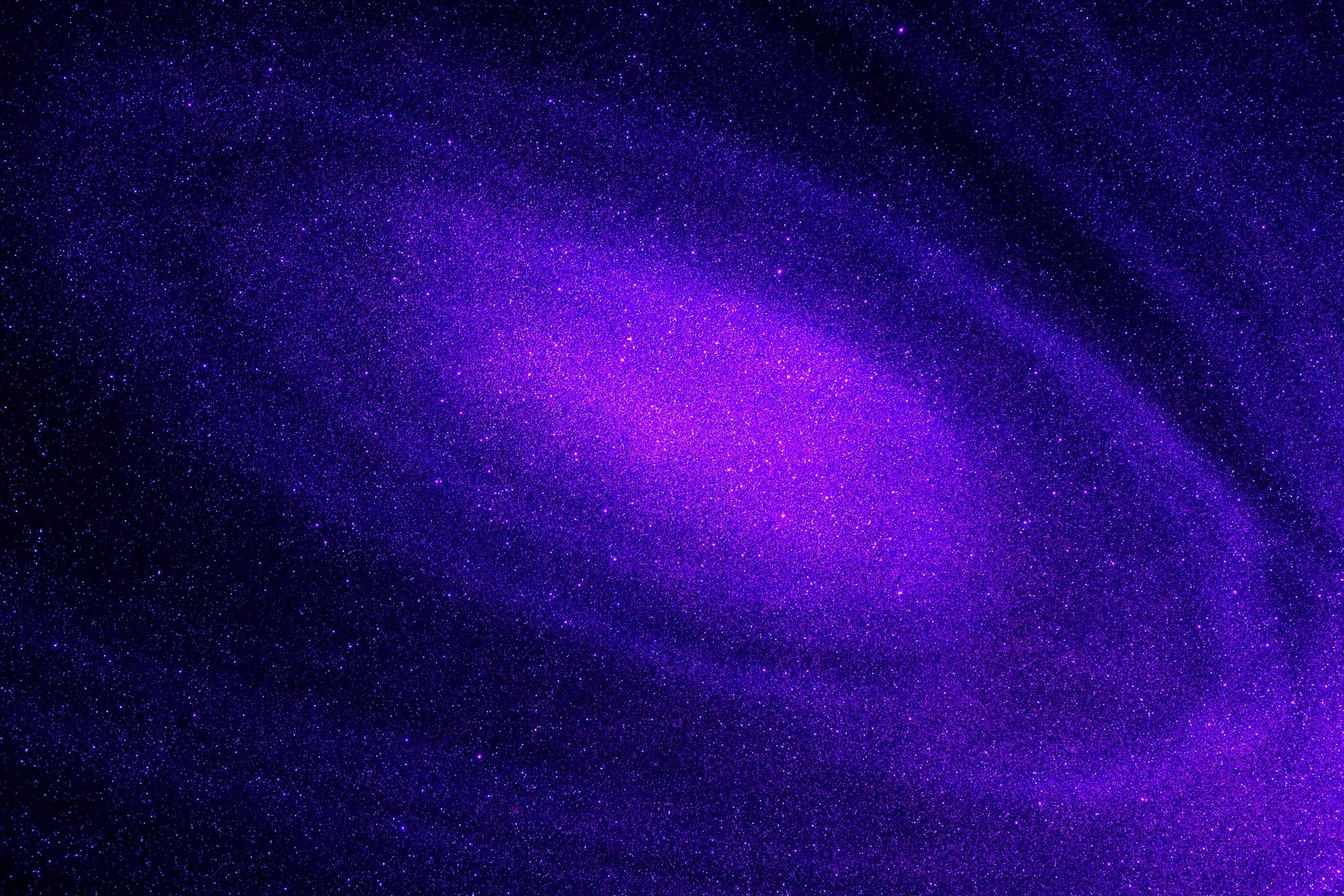 A deep-purple and magenta cosmic nebula glowing with violet light against a dark, star-flecked sky